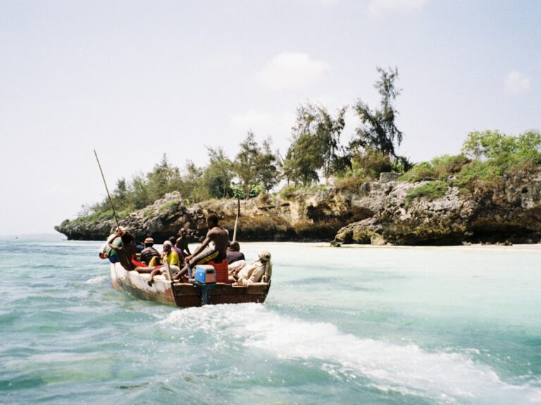 people riding on boat on body of water during daytime