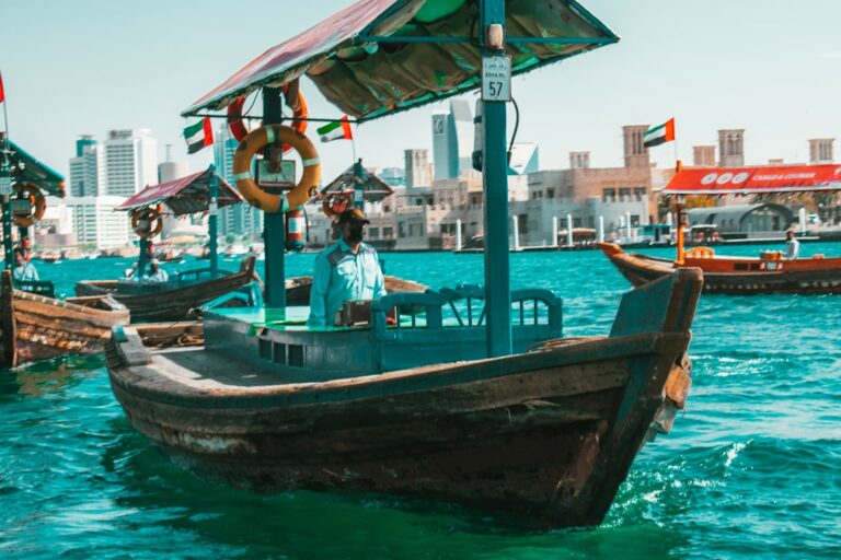 a boat in a body of water near a city