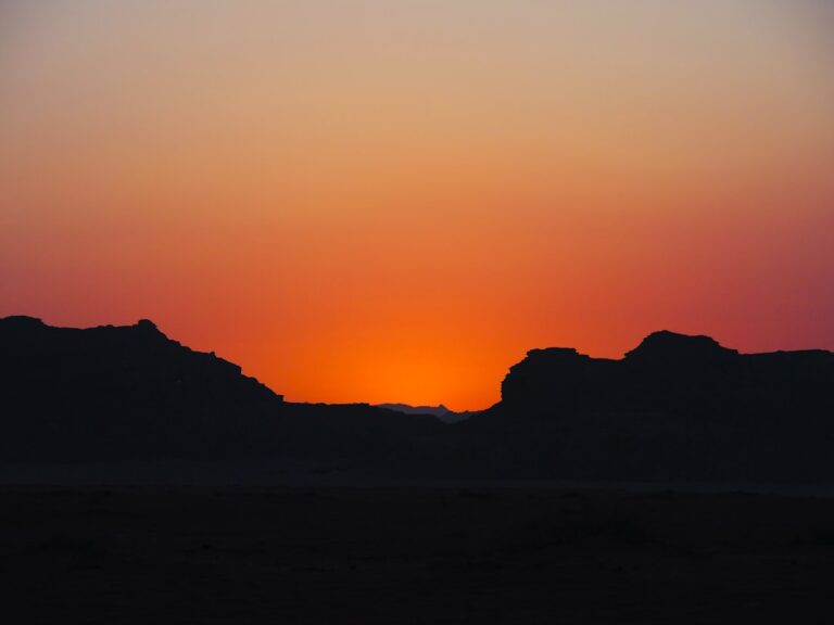 a sunset over a mountain range