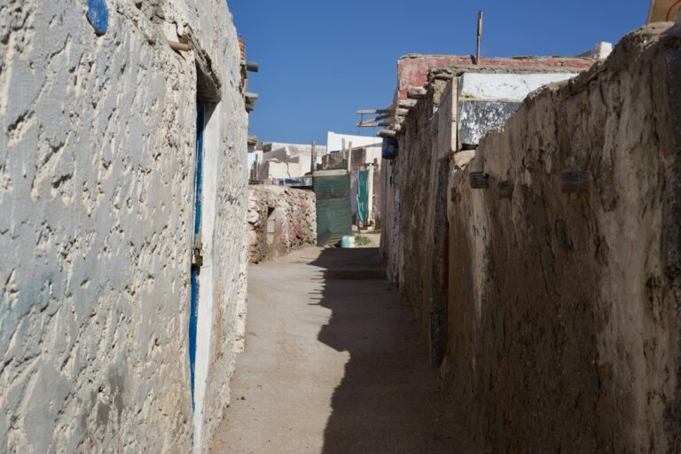 a narrow alley between stone buildings