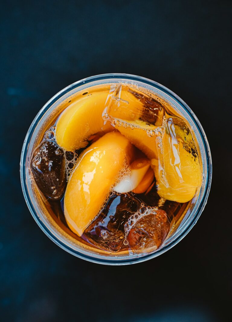 Plastic glass of peach iced tea with lemongrass