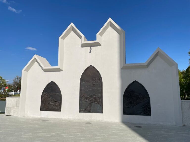 a white church with three arched windows on a sunny day