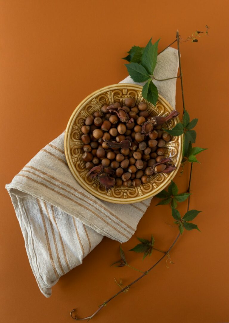 Hazelnut plate with a fabric on ochre background.