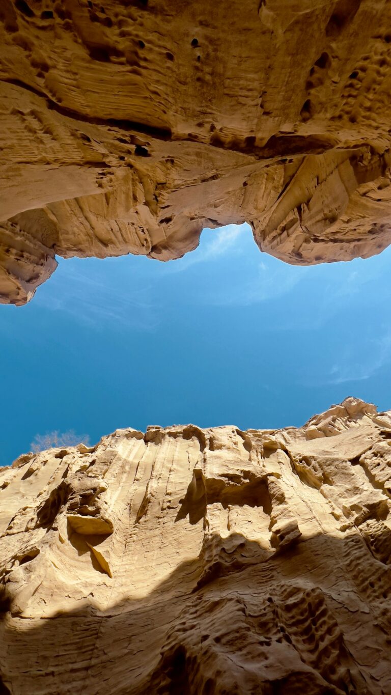 a rock formation with a blue sky in the background