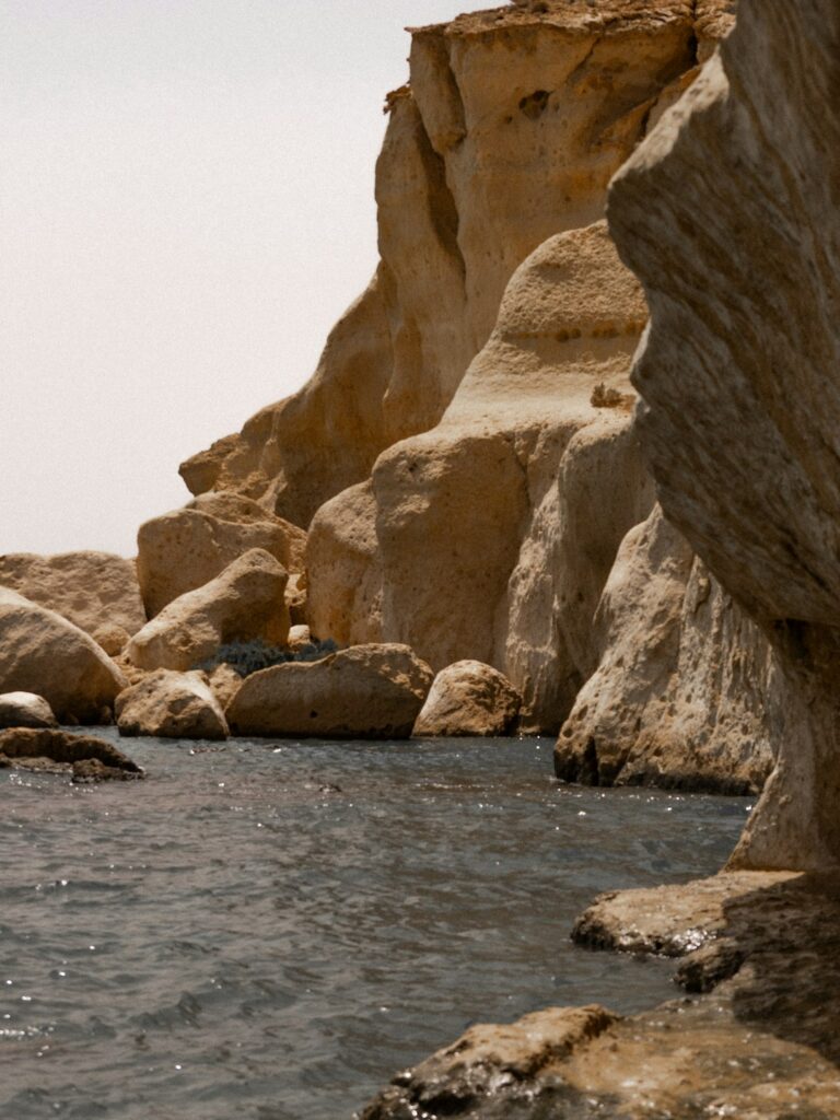 A body of water surrounded by large rocks