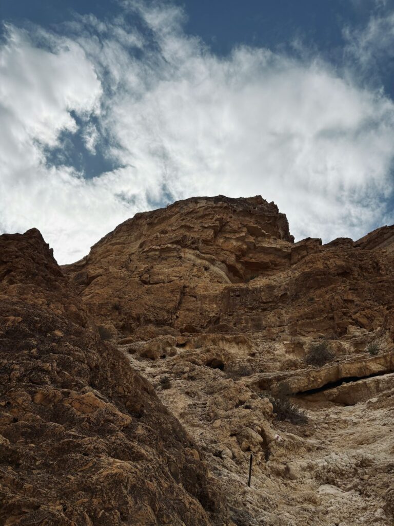 A man climbing up the side of a mountain