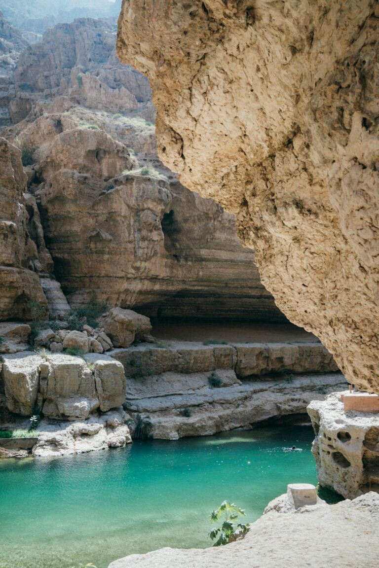 A turquoise pool nestled in rocky canyon walls.