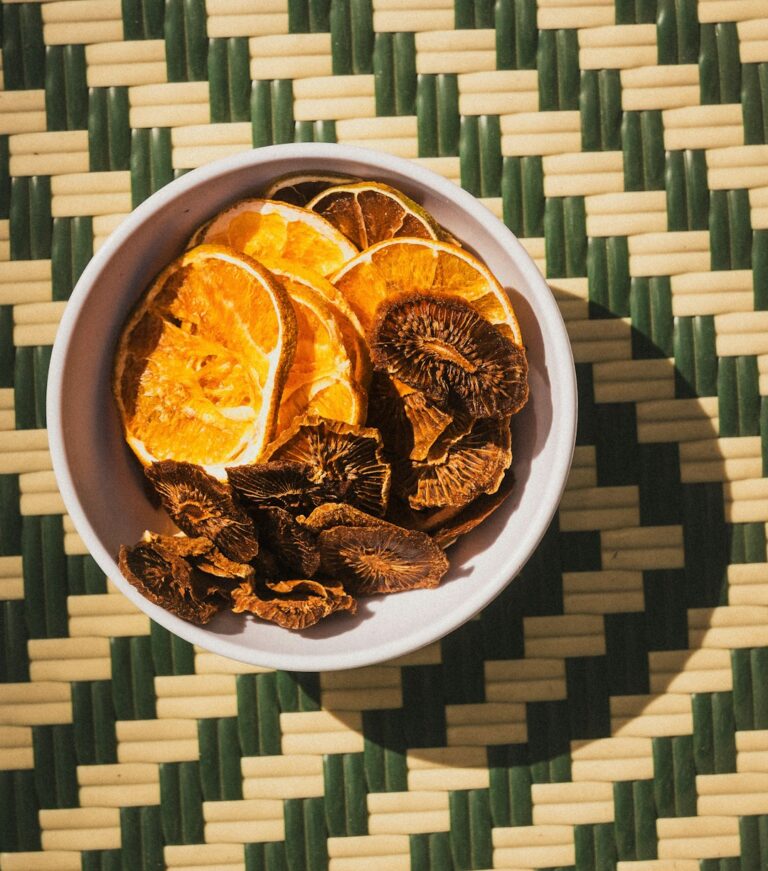 Dried oranges and mushrooms are in a bowl.