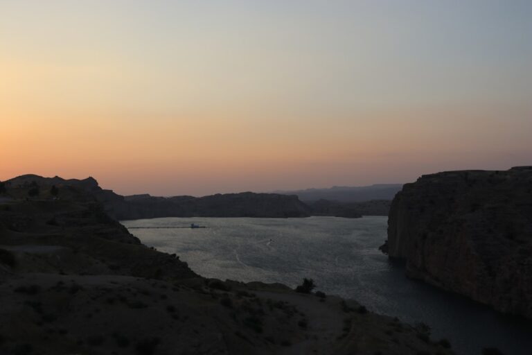 Sunset over a wide body of water.