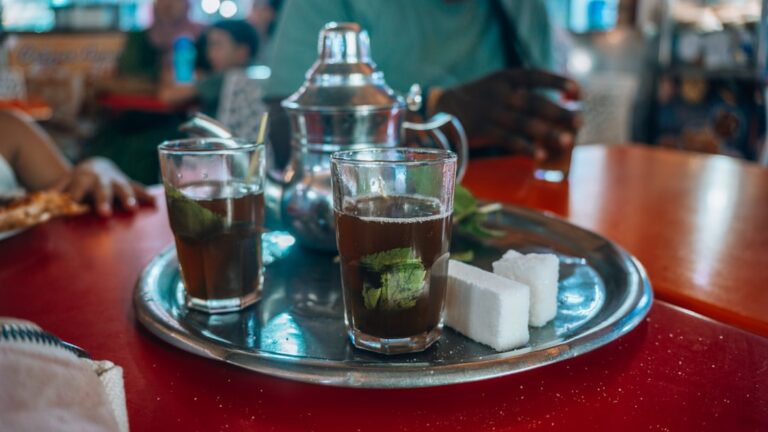 Mint tea and sweets are served on a tray.