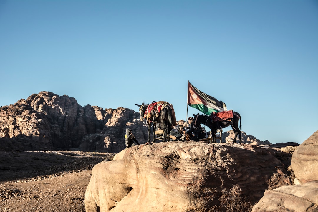 people on brown rock formation under blue sky during daytime