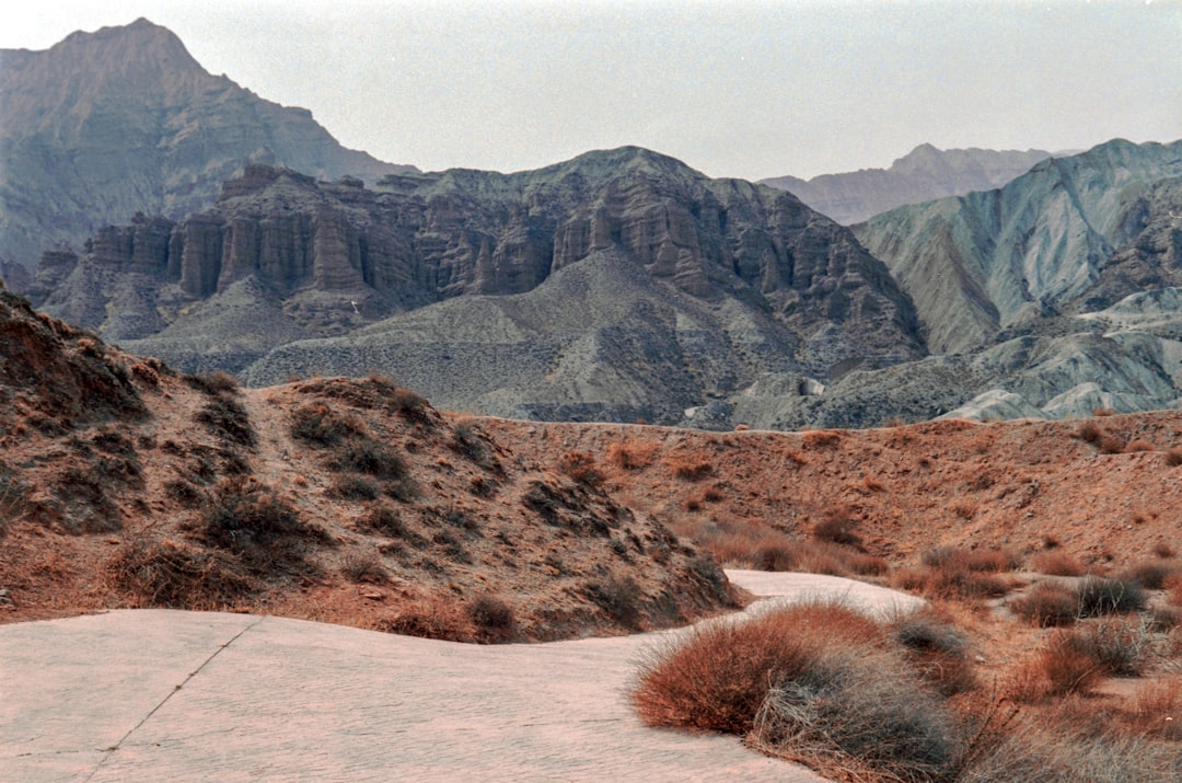 a man riding a skateboard down a dirt road