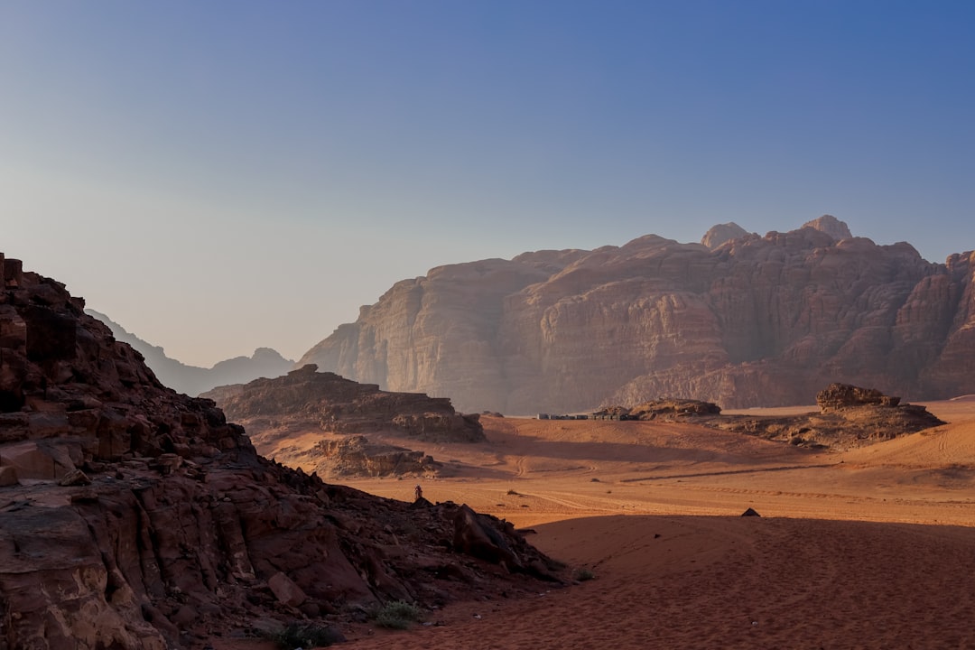a desert with a mountain range in the background