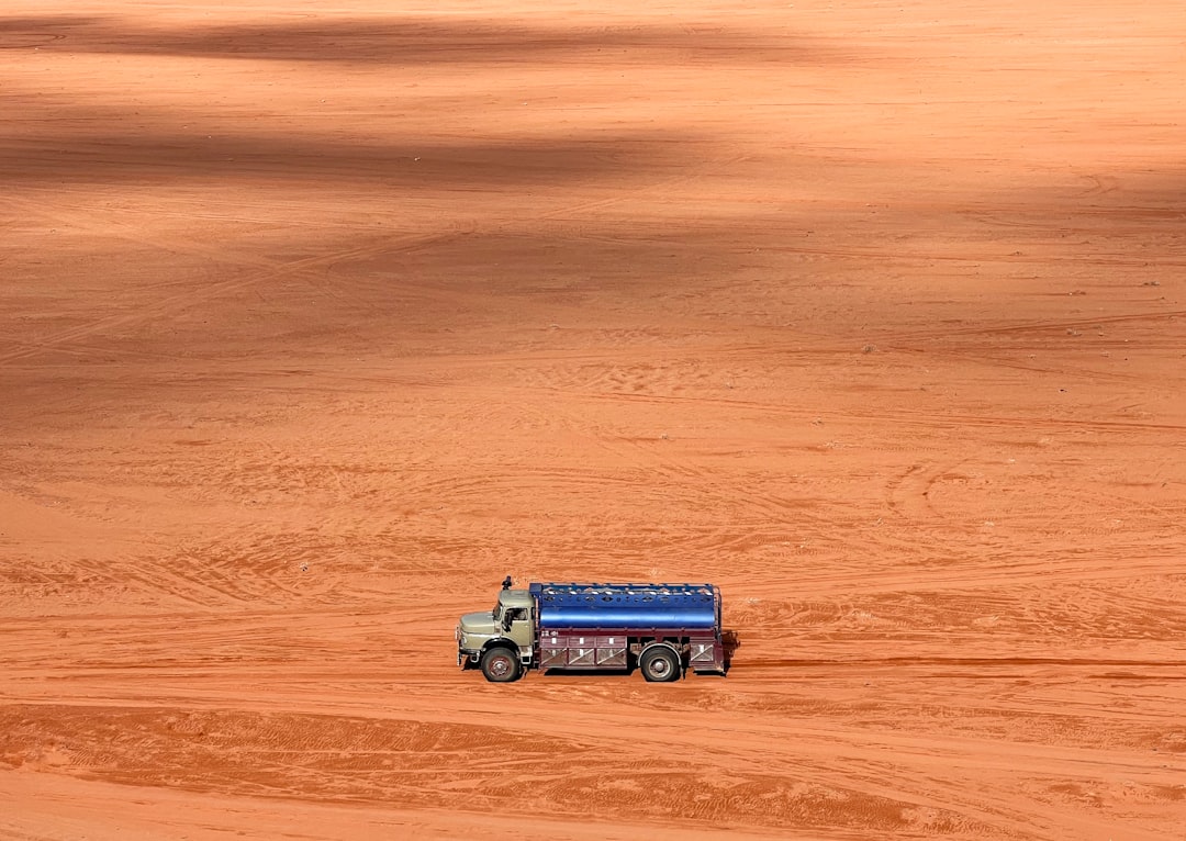 a truck is parked in the middle of a dirt field